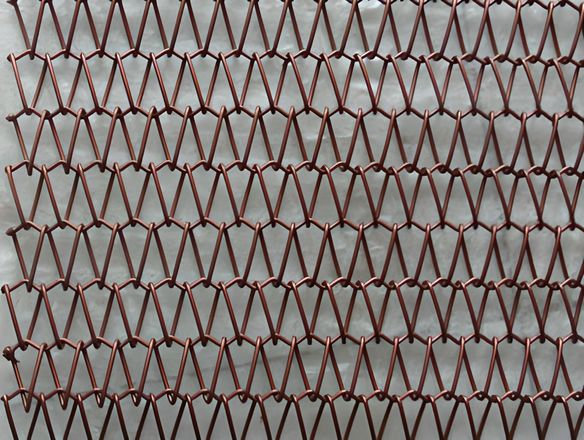 A copper balanced weave conveyor belt on the white background.