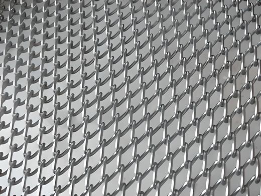 A piece of chain link conveyor belt on the ground.