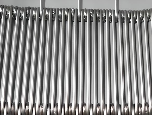 Eye link conveyor belt with ring in the cross wire spacing.