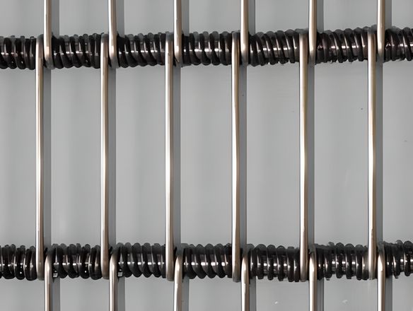 Eye link conveyor belt with rings in the cross wire spacing.