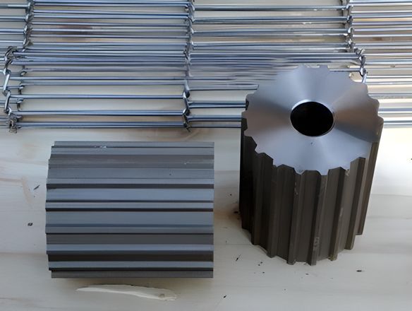 Two metal idler wheel is placed beside the rod network conveyor belt.