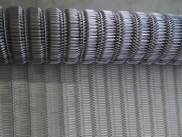 A roll of rod network conveyor belt with concave surface.